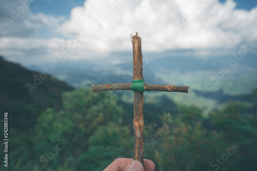 The cross with nature in the forest on the hill is the Blackground.