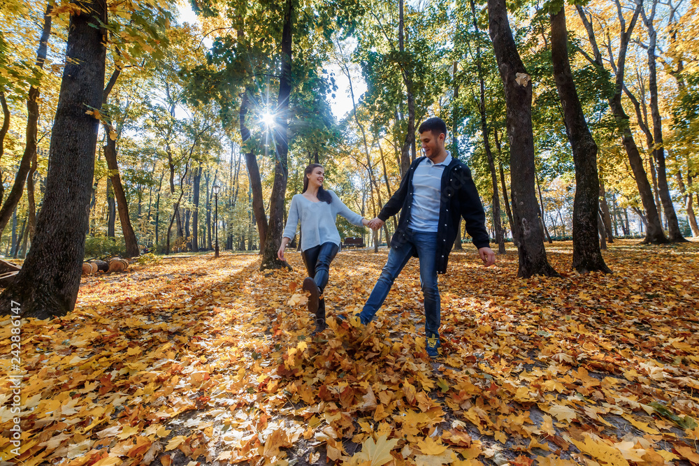 Natural photos of a happy couple in love having fun outside on a sunny autumn day. Togetherness and happiness concept