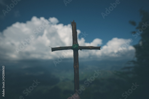 The cross with nature in the forest on the hill is the Blackground.