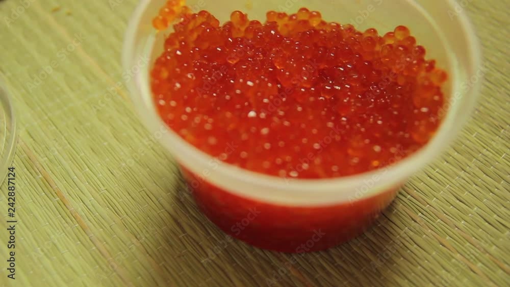 The camera pulls up A jar of red caviar The camera pulls up A jar of red caviar