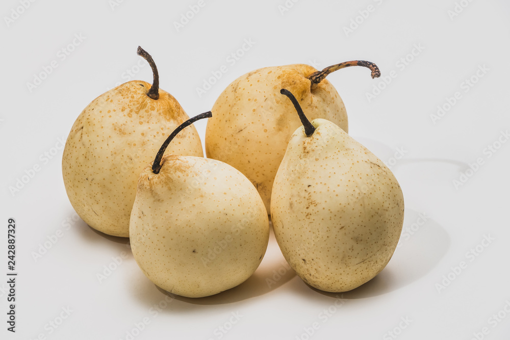 Four beautiful yellow Nesha pears on a white background Four beautiful yellow Nesha pears on a white background