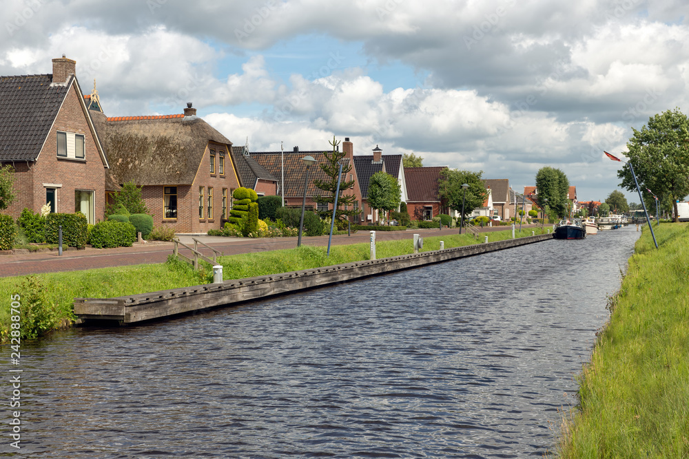 Dutch village Appelscha in Friesland with houses along a canal