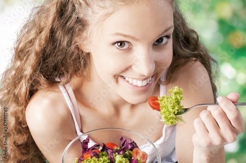 Attractive caucasian smiling woman with salad isolated