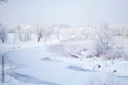 Winter Park. Bushes and trees are covered with thick frost. Visible icebound river.