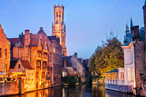 View of river canal and Belfort (Belfry) tower at twilight from Rozenhoedkaai,famous boat tour point in Bruges, Belgium. © varandah