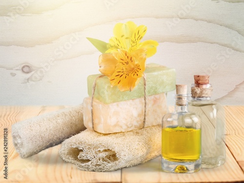 Healthy spa concept with handmade soap bars, oil bottles, sponge