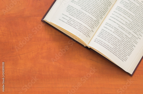 Open book on wooden background