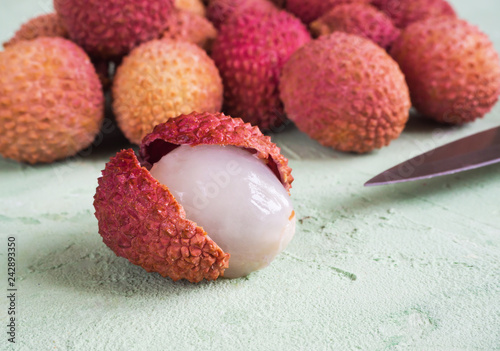 Ripe lychees on a green table. 
