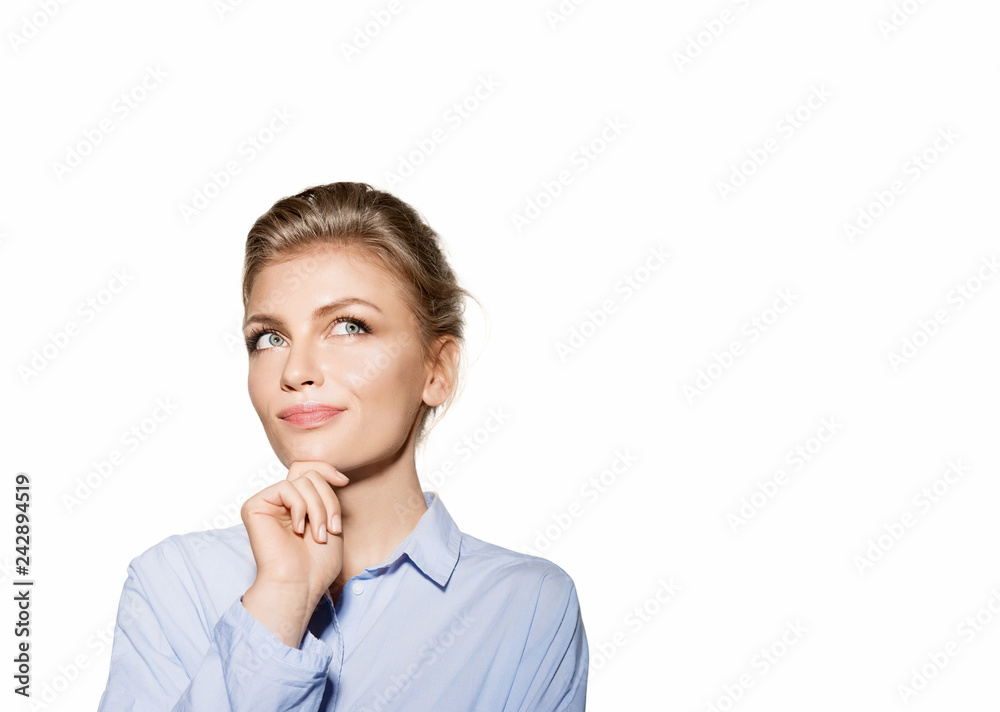 Portrait of beautiful thoughtful young woman in blue shirt. Pretty blonde model with natural makeup on white background. Copy space for text. Beauty concept Portrait of beautiful thoughtful young woman in blue shirt. Pretty blonde model with natural makeup on white background. Copy space for text. Beauty concept