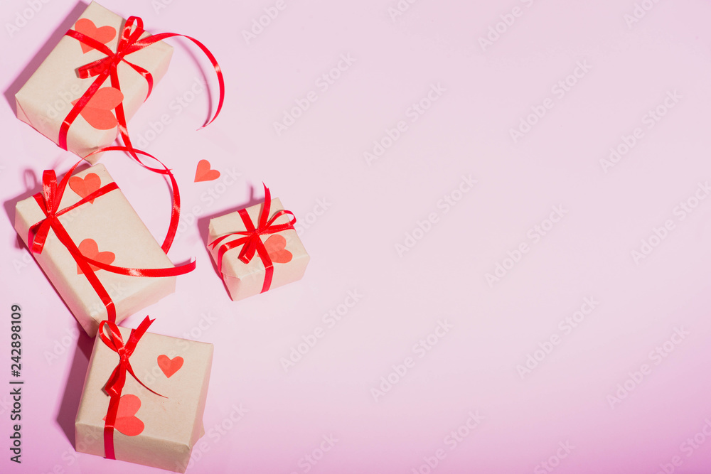 Valentine's Day gift on a pink background lie with a red ribbon hearts with love frame place for text isolate