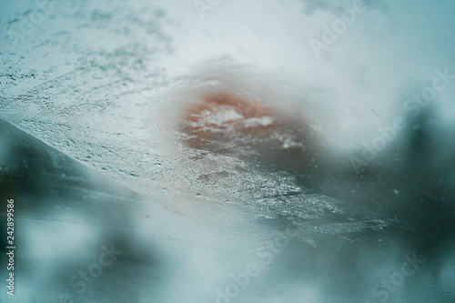 Glass Window Covered With Ice And Rain Drops