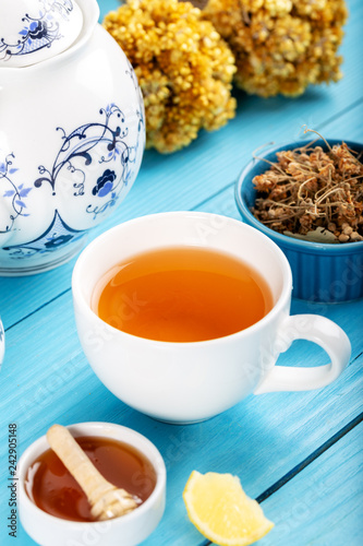 Cup of Linden Tea, Dried Linden Flowers in Cup with honey and lemon on wooden background.