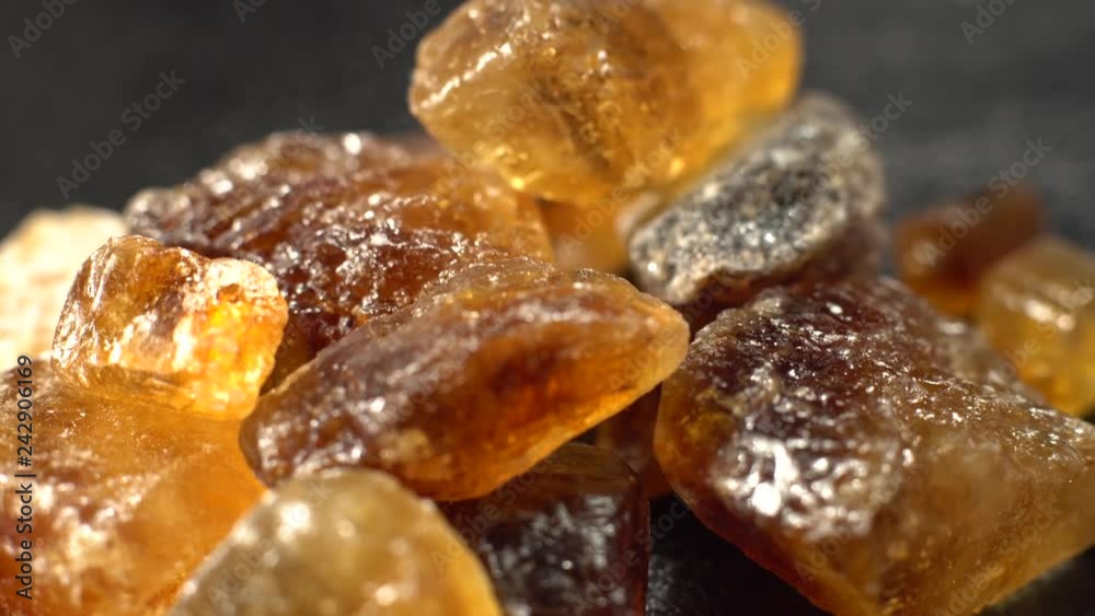 Large crystals of natural cane sugar . Brown lump caramelized, close-up. Large crystals of natural cane sugar . Brown lump caramelized, close-up.