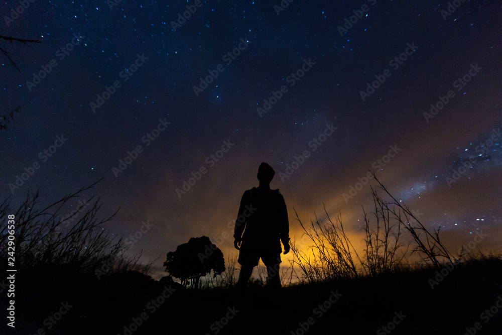 Fototapeta premium silhouette of a man under a starry sky
