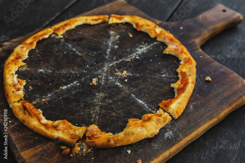 Canvas Print Crunchy crusts of delicious pizza on the wooden board