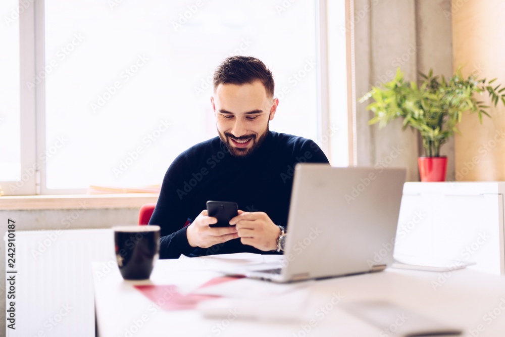 Happy caucasian young man checking social media portals