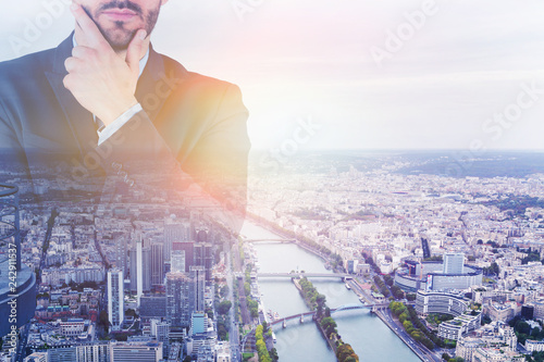 Thoughtful businessman in city with river