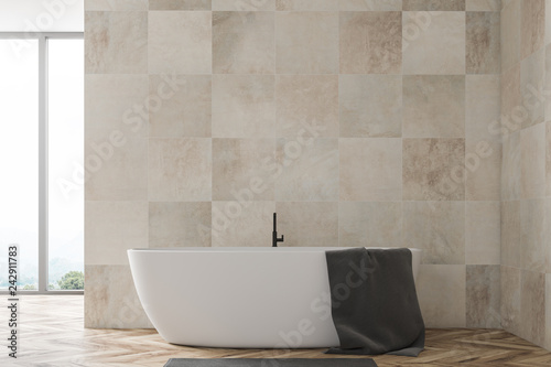 Beige tile bathroom with tub