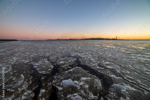 dramatic red sunset over the frozen sea on the beach