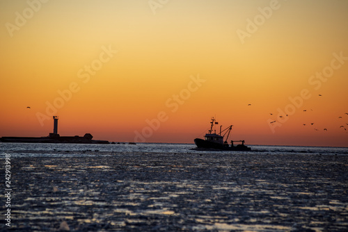 dramatic red sunset over the frozen sea on the beach