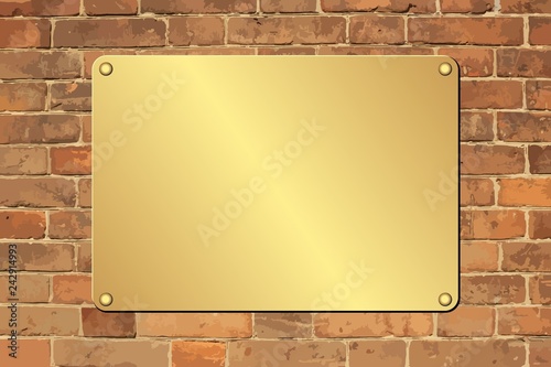 golden plaque on brick wall