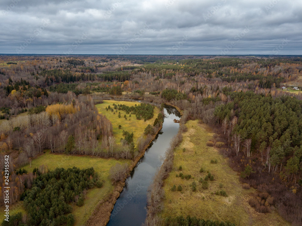 drone image. aerial view of rural area with snake river in forest