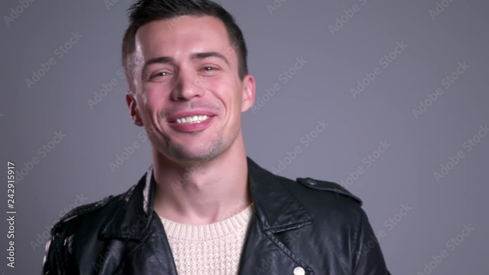 Closeup portrait of attractive caucasian man laughing while looking at camera Closeup portrait of attractive caucasian man laughing while looking at camera