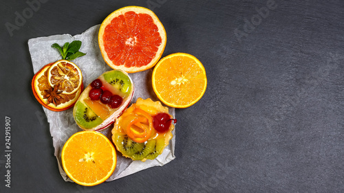 healthy food beautiful and tasty fruit isolated on dark background, shale board. top view, space for text