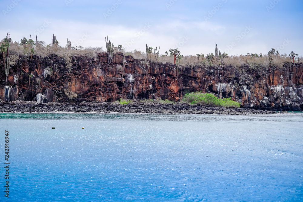 Beautiful outdoor view of famous cliff located in San Cristobal Island in Galapagos in a beautiful blue water