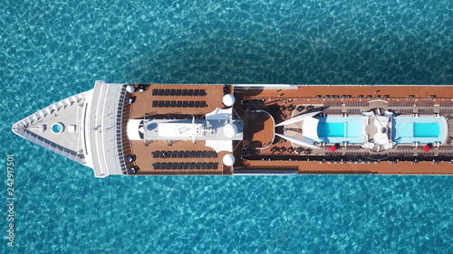 Aerial drone top view photo of cruise liner ship docked in tropical exotic bay with turquoise sea