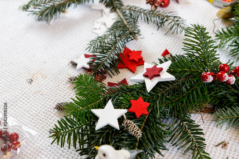 Decoration of handmade red and white advent christmas wreath from fir Decoration of handmade red and white advent christmas wreath from fir