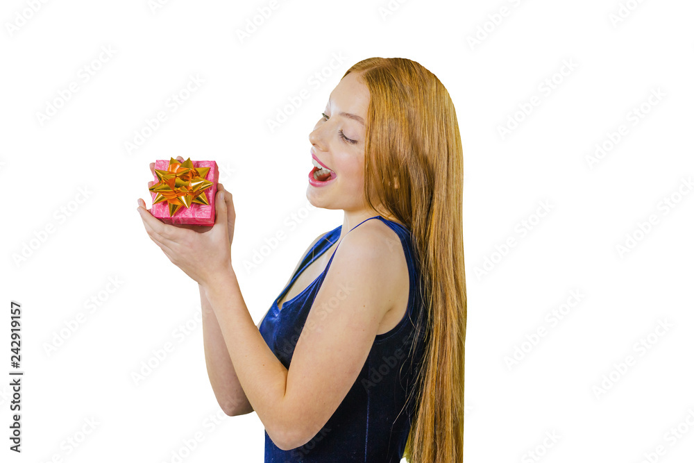 Beautiful and joyful red-haired girl in blue dress with a gift in her hands for Christmas on an isolated background