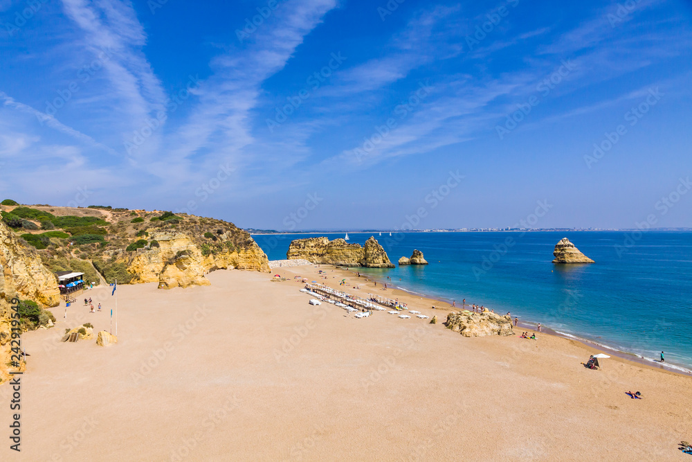 Praia da Dona Ana beach, Lagos, Algarve region, Portugal. Praia Dona Ana surrounded by steep colourful strata cliffs. One of the most picturesque beaches in Algarve. One of the best beach of Portugal Praia da Dona Ana beach, Lagos, Algarve region, Portugal. Praia Dona Ana surrounded by steep colourful strata cliffs. One of the most picturesque beaches in Algarve. One of the best beach of Portugal