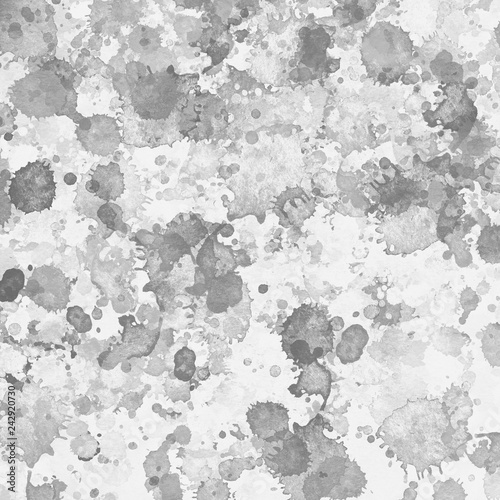 Gray paint splatter effect texture on white paper background. Artistic backdrop. Different paint drops.