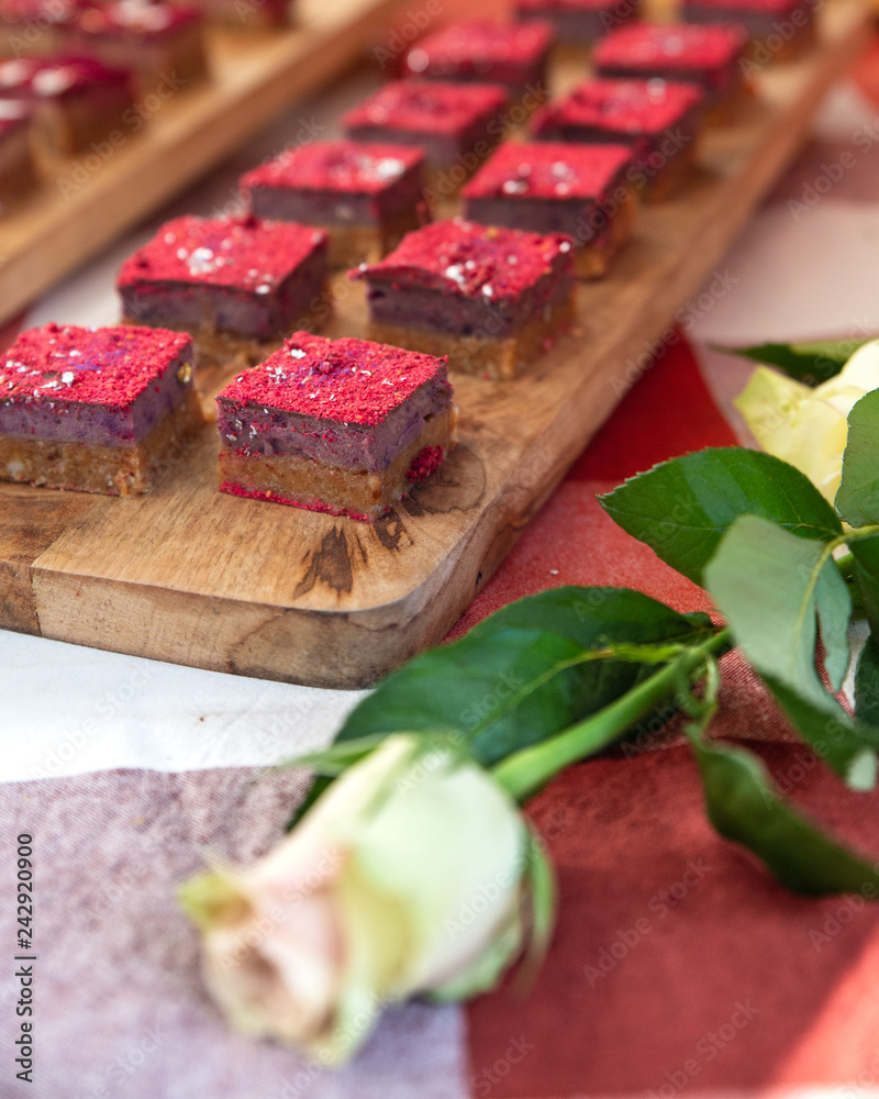 Display of beautiful sweet miniature cakes with a white rose