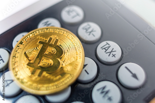 Bitcoin coin with calculator as a tax payment concept