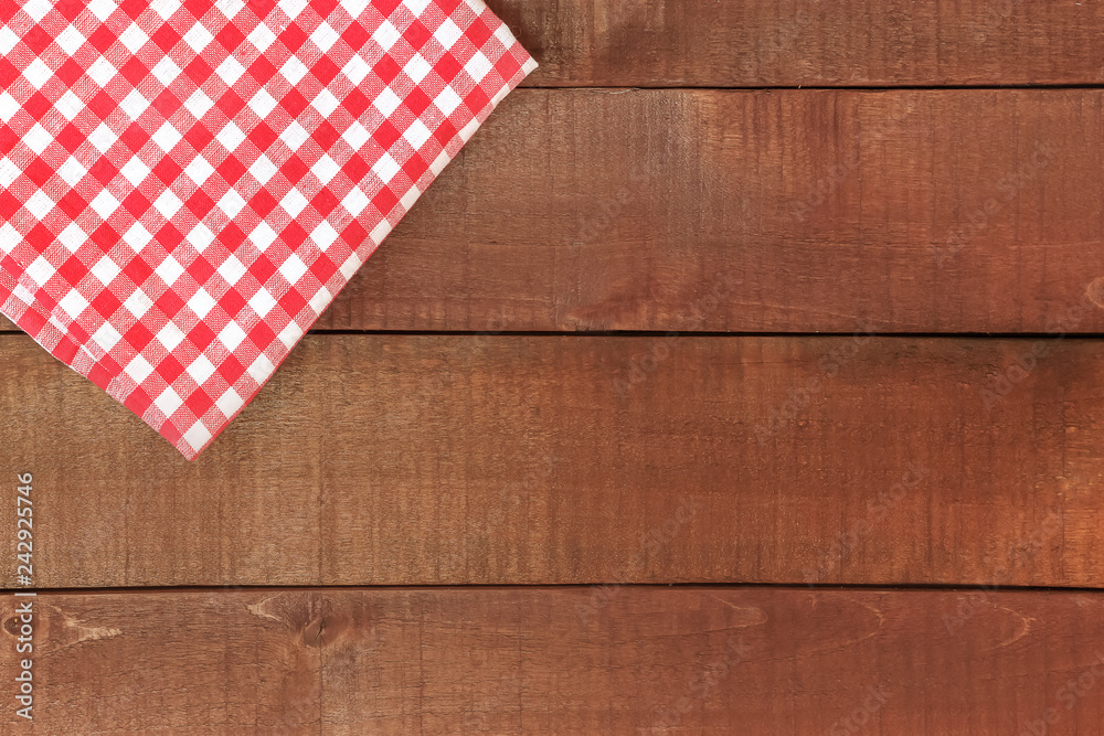 Wooden table and red tablecloth or napkin Wooden table and red tablecloth or napkin
