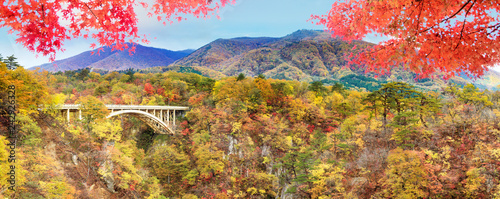 autumn colors of Naruko Gorge in Japan and nice blue and cloud background photo