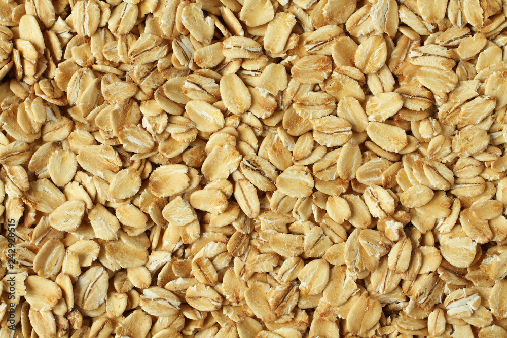 Food background - oat-flakes situated arbitrarily Food background - oat-flakes situated arbitrarily