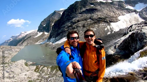 Young Caucasian couple taking portrait selfie Heli hiking  photo