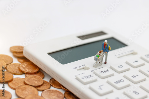 Miniatrue people: Shoppers buy goods on sale with discount tray on calculator and coins. Tourism, shopping or business concept.