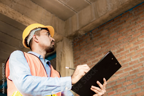 Engineer or inspector checking progressing work in construction site