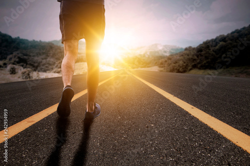 Goal and Strive concept, Runner run on road with sun rising.