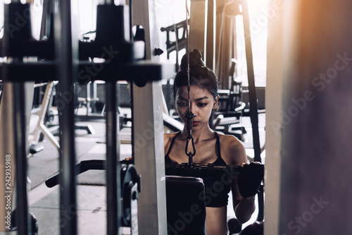 Women are pulling gym equipment in a sports club.