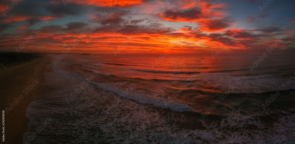 Bright red sunrise over Windang Beach, NSW, Australia