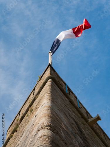 French flag on the wall of an old fort in Saint-Malo