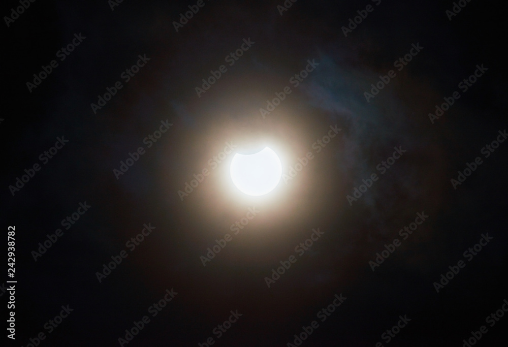 Solar Eclipse. Partial Solar Eclipse on a cloudy day. Solar Eclipse. Partial Solar Eclipse on a cloudy day.