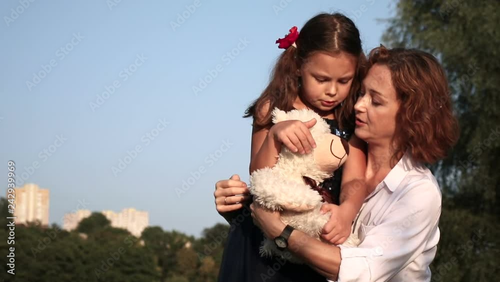 Happy mother and daughter outdoors. Warm family relationships Happy mother and daughter outdoors. Warm family relationships