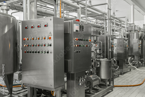 electronic control panel and tank at a milk factory. equipment at the dairy plant