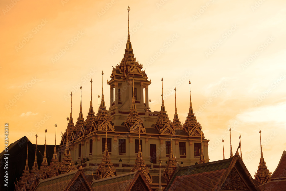 Chedi Loha Prasat of the Buddhist temple Wat Ratchanadda against the background of the sunset sky. Bangkok, Thailand